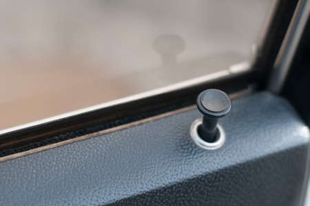 Lock Button in old car black color near windowの写真素材