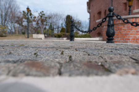 Old city view from bottom with black iron fence with chainの写真素材