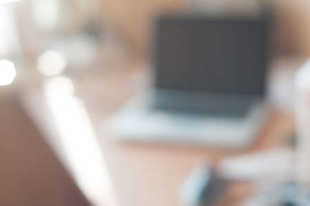 Background defocused office room with table and laptopの写真素材
