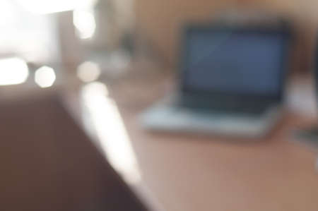 Background defocused office room with table and laptopの写真素材
