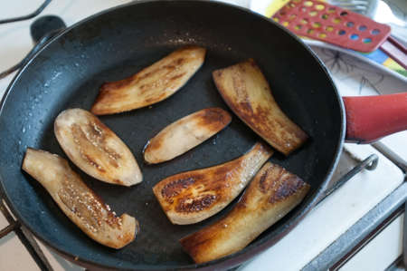 Sliced eggplant on frying panの写真素材