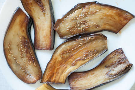 Sliced eggplant on white plateの写真素材