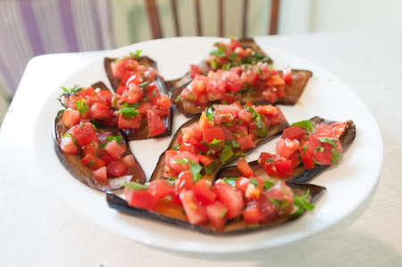Sliced eggplant on white plate at homeの写真素材