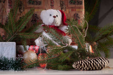 Teddy bear in santa hat and christmas presents with decoratioの写真素材