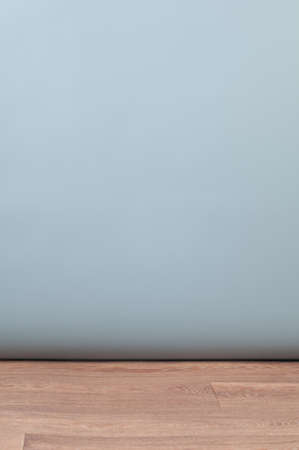 Grey silver color studio background and wooden parquet floor