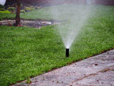 Garden irrigation, sprinkler working. Irrigation system throwing water drops away. Garden irrigation...
