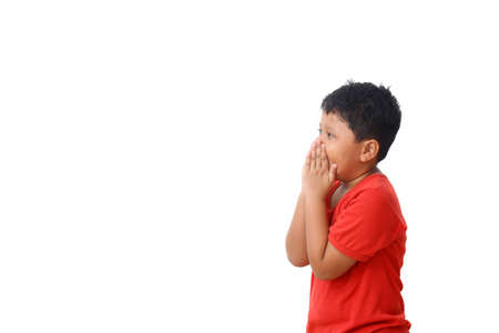 Asian boy in red shirt with surprise expression while looking at blank space. Isolated on white...