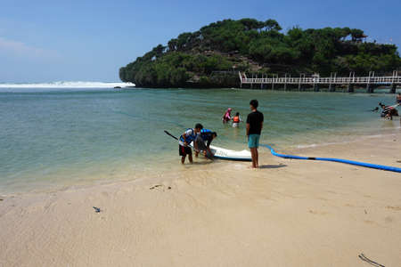Yogyakarta, Indonesia - Okt 30, 2020 : Tourists are enjoying a vacation at Drini beach, Wonosari, Gunung Kidul, Yogyakartaのeditorial素材