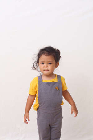 Adorable asian girl standing. Isolated on white backgroundの写真素材