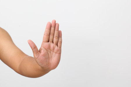 Man's hand with stop gesture. Isolated on white backgroundの写真素材