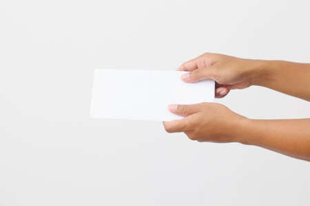 Man's hand holding envelope isolated on white background. Close up