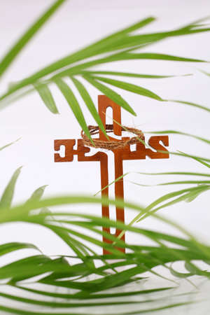 Cross and palm on white background with copyspace. Palm Sunday conceptの写真素材