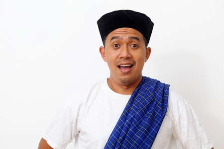 Portrait of happy asian man using cap. Isolated on white background. Ramadan conceptの写真素材
