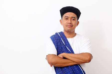 Portrait of happy asian man using cap. Isolated on white background. Ramadan conceptの写真素材