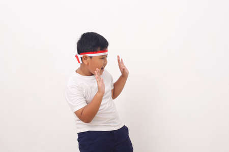 Wow and shocked face of Asian boy point to present an empty space of content. Advertising model concept.の写真素材