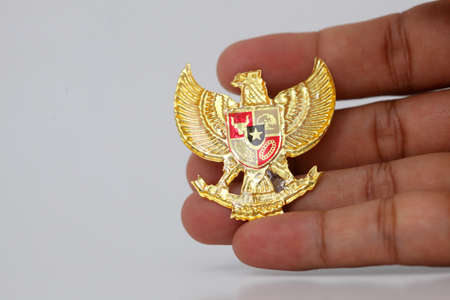 Hand with Garuda Pancasila. Indonesia independence day 17th August. Isolated on whiteの写真素材