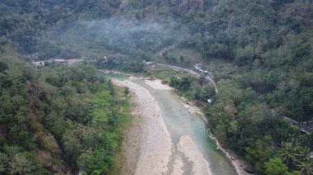 Beautiful aerial view of a river in the middle of the mountains in the morning