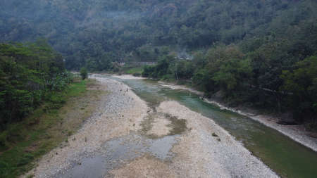 Beautiful aerial view of a river in the middle of the mountains in the morning