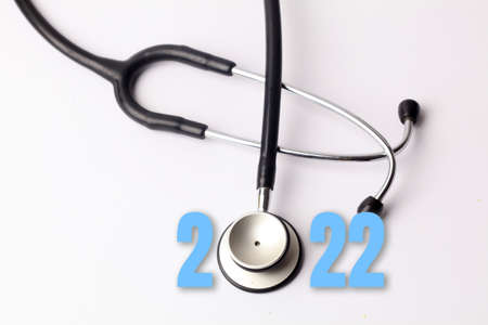 Stethoscope with 2022 number on white background. Happy New Year for healthcare and medical banner/calendar cover. Creative idea for new trend in medicine treatment and diagnosis concept.の写真素材