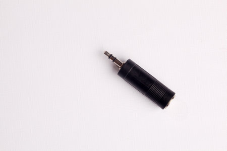Adapter 6.5 mm to 3.5 mm aux audio jack on a white background.の写真素材