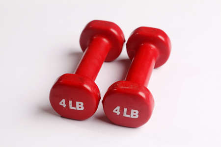 Two red dumbbells isolated on white background