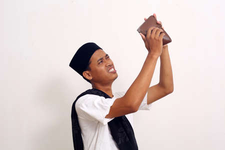 Poor and depressed Asian man wear gray shirt. Isolated on white background. Concept of desperate life.の写真素材