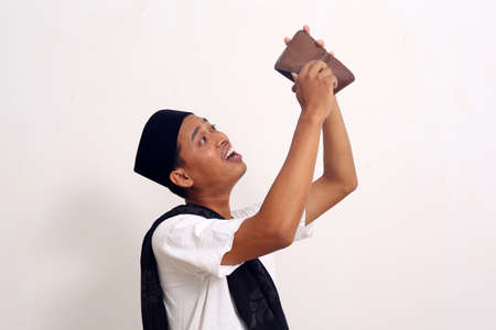 Poor and depressed Asian man wear gray shirt. Isolated on white background. Concept of desperate...