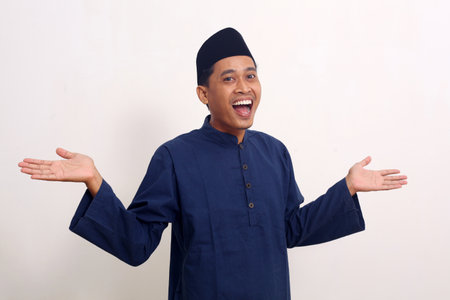 Surprised asian muslim man while looking something on empty space. Isolated on white with copyspaceの写真素材