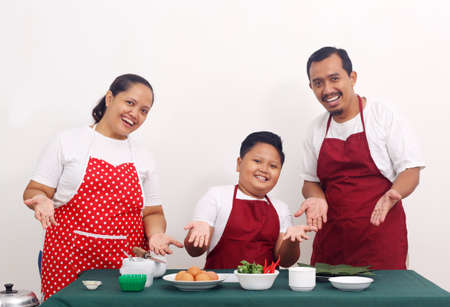 Happy asian family is ready to cooking. Parenting concept. Isolated on white backgroundの写真素材