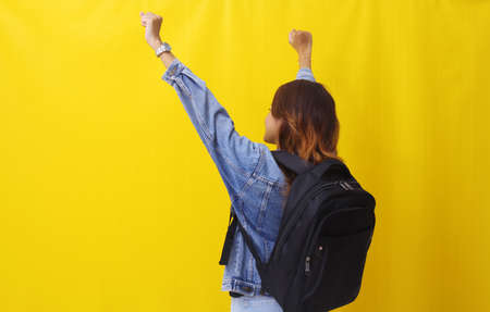 Back view of asian young woman standing while carrying school bag. Successful concept.の写真素材