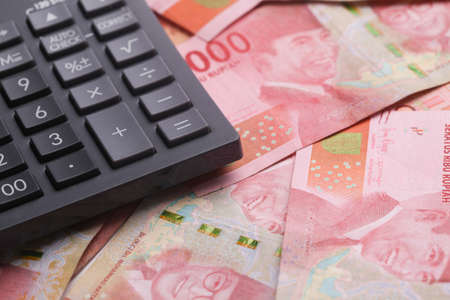 Calculator On Indonesian rupiah cash banknotes moneyの写真素材