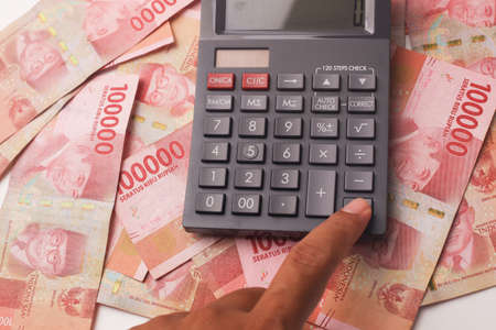 Calculator On Indonesian rupiah cash banknotes moneyの写真素材
