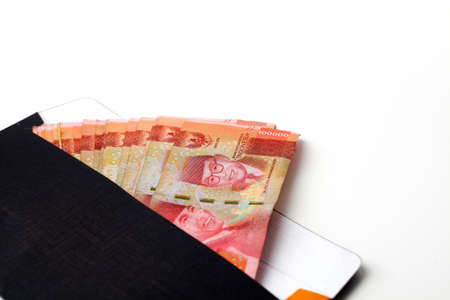 Indonesian money in the envelope. Isolated on white background