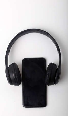 Black headphones on smartphone music online concept, mockup, isolate on white