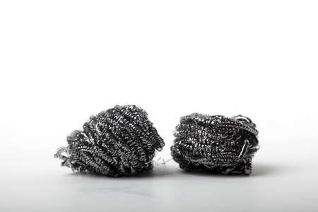 Metal sponge for cleaning and washing dishes on white background with copyspaceの写真素材