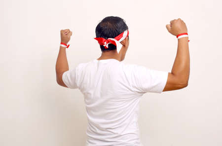 Back view of a man standing while clenching his hand. Indonesian independence day concept