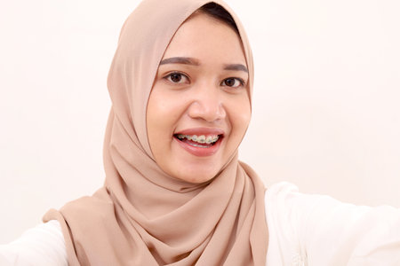 Portrait of beautiful young asian muslim woman face with veiled. Isolated on whiteの写真素材