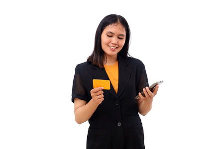 Happy young asian business woman holding cell phone and a blank card. Online shopping concept