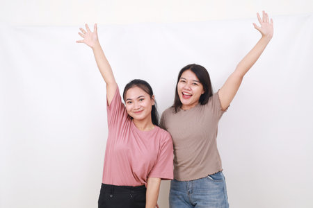 Portrait of youth millennial raise arms rejoice free time weekend holidays glad content scream shoutの写真素材