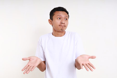 Asian funny man standing with confused face expression and question hand gesture