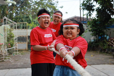 Indonesian family celebrate Indonesia independence day with outdoor contestの写真素材