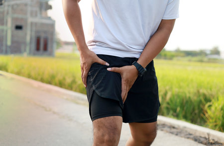 Asian adult male with muscle pain during running. runner have leg ache due to Groin Pull. Sports...