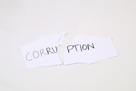 Stop and fight corruption concept. A piece torn paper with written word corruption.の写真素材