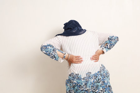 Back view of asian elderly woman having problem with her back