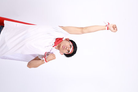 Asian men standing to celebrate Indonesia's independence with a flying pose
