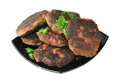 Beef patties on a plate. Isolated on white.