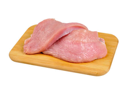 Turkey meat on a wooden board. Isolated on white.の写真素材