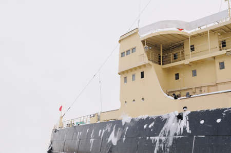 Icebreaker at sea in the snow against cloudy sky.の写真素材