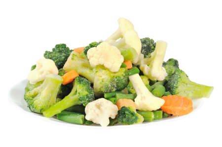Cauliflower, broccoli, carrots and beans on a plate. Isolated on white.の写真素材