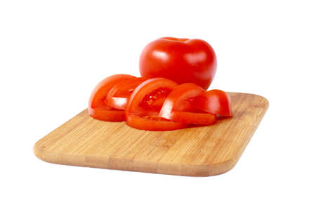 Sliced tomato on the board, isolated on whiteの写真素材